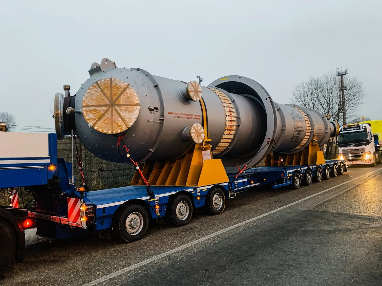 Pressure vessel on a low-bed trailer at dusk