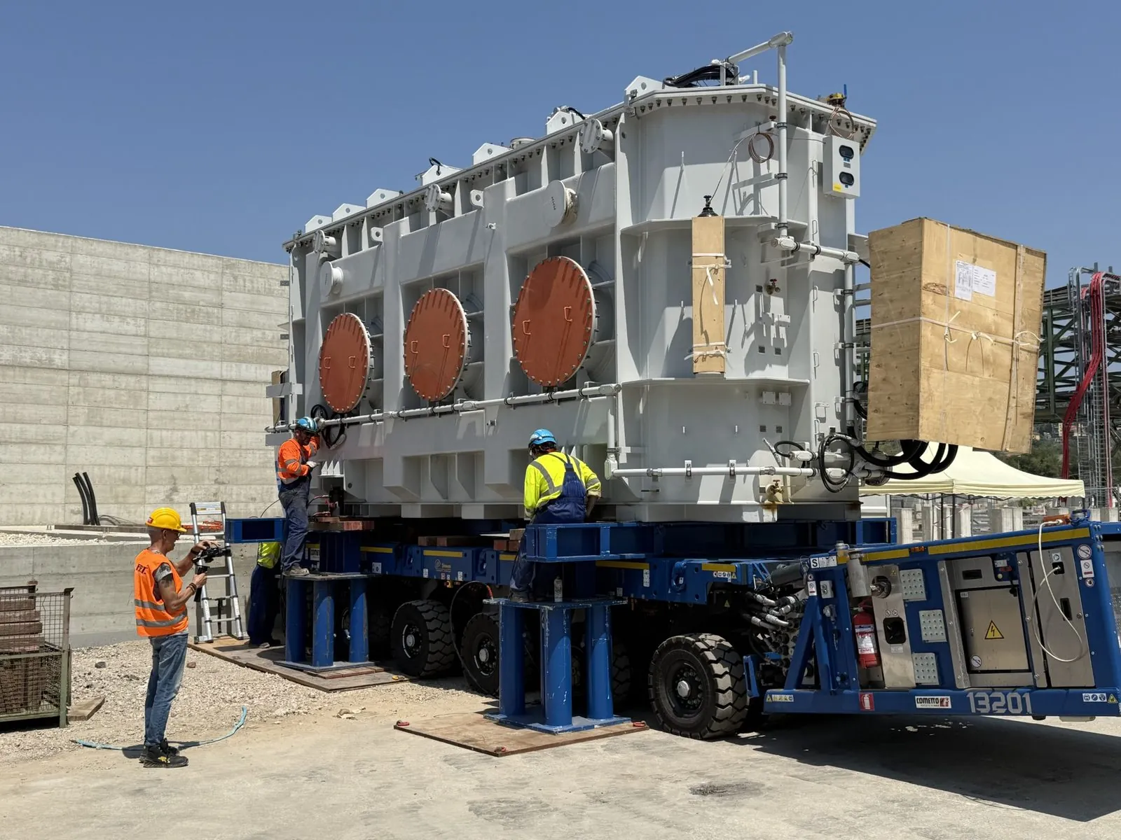 Power transformer on an SPMT at the substation, ISCOTRANS team in attendance